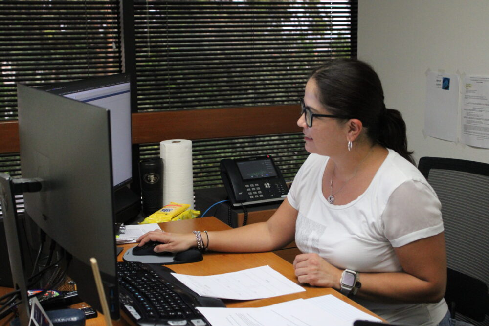Luz at her desk